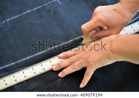 Close up measure on cloth with hand, tailor work