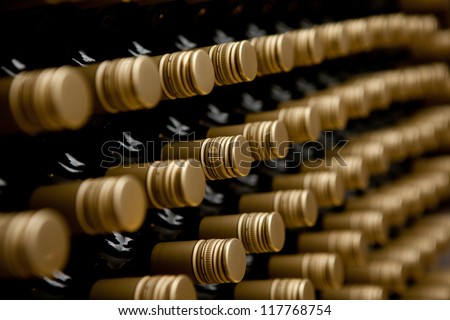 Wine bottles in a row. tops of alcohol in winery or cellar