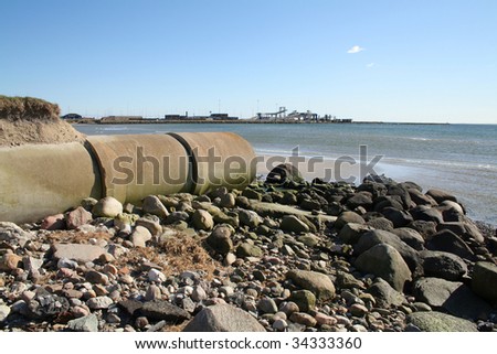 waste pipe or drainage polluting environment. concrete pipes by beach
