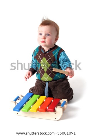 Child Playing Music On Wood Xylophone Instrument. Toddler Boy With