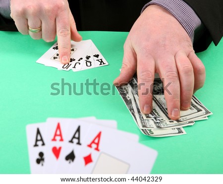 game of cards or poker. gambling and winning money or losing. hand with four aces and stack of dollar bills