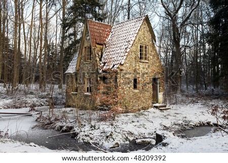 ruin in forest. lodge or small house abandoned and falling down. architecture built in flint and stone with water around or in lake in winter