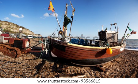 fishing industry, trawler or fishing boat on the beach in seaside resort of Hastings in England. South UK shoreline