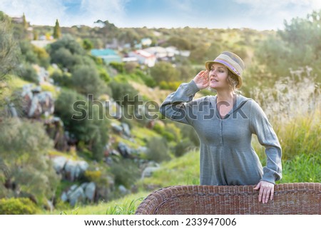 Woman  in hat listening sound in nature