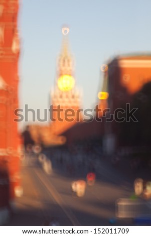 Blurred movement of people and cars in the city. The halo effect around bright surfaces and reflections. Golden dome with a diffuse halo and glare. Halos around people.