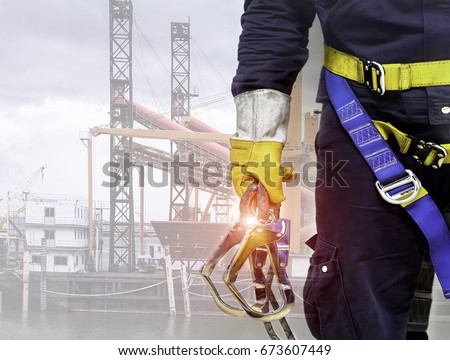 Close-up harnesses and gloves, Working at height equipment. Fall arrestor device for worker with double hooks for safety body harness on selective focus, Safety background and  beautiful, Safety first