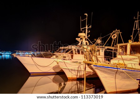 A night shot of  fishing boats in harbor.