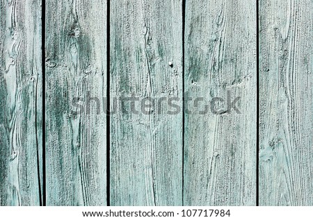 Light blue-green painted weathered wooden fence texture