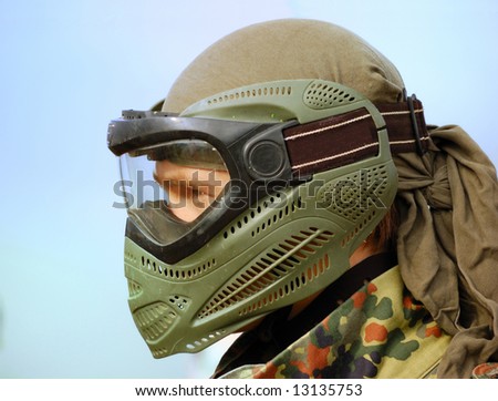 Paintball warrior with mask against a blue background