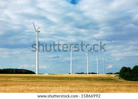 Line of wind turbines in a wheat field