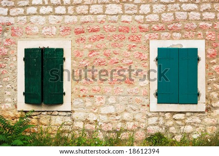 Windows of a Mediterranean house with wooden shutters
