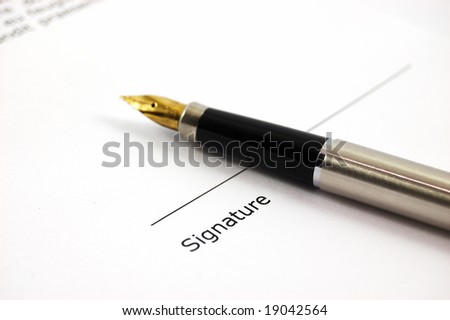 A form of a document with a place for a signature and a gold-nibbed pen