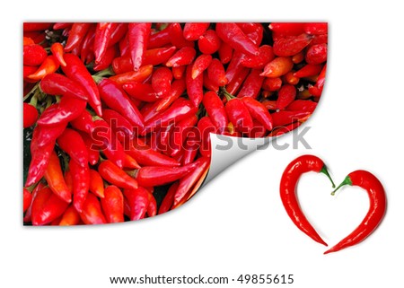 A pile of red chili peppers picture with two peppers forming a shape of heart. Hot lover symbol.