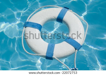 Closeup of a life preserver ring floating on beautiful blue water