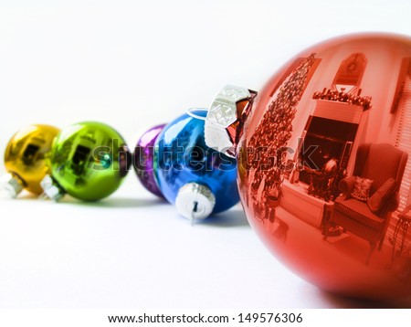 These shiny Christmas Ornaments reflect the Holiday Season of this decorated living room with  Christmas Tree and holiday decorations