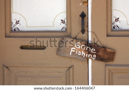 This Gone Fishing sign hanging on the front door of an old country store tells a story of the simple life of a store keeper during a warm rural summer day.