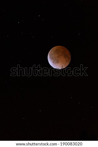 This is a photograph of the Lunar Eclipse Blood Moon moving out of its maximum stage at 3:00 am Central Time. Background star field added from same sky location later.