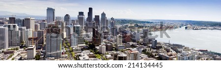Beautiful aerial view of Seattle\'s downtown skyline including business development, sports stadiums, new construction, and especially the Port of Seattle and large container ship harbor operation.