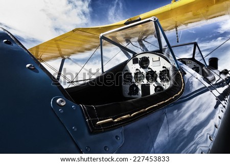 This nostalgic photo treatment of a bi-wing aircraft cockpit adds to the historical appeal aviation had in the early 1900\'s.