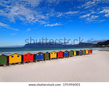 Row of wooden brightly colored huts on Sunrise Beach. Atlantic ocean. Cape Town.  Muizenberg. South Africa