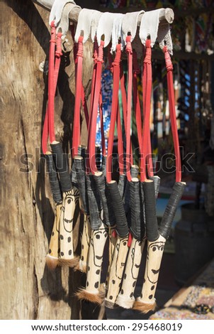 African unique traditional handmade colorful wooden rubber leather slingshots. Local craft market in South Africa. Craftsmanship.