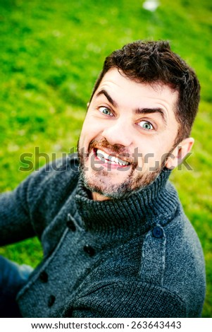 Funny man is smiling with white teeth and open mouth