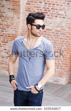 attractive young male model posing outdoors