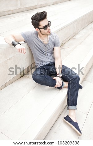 attractive young male fashion model dressed casual - outdoor