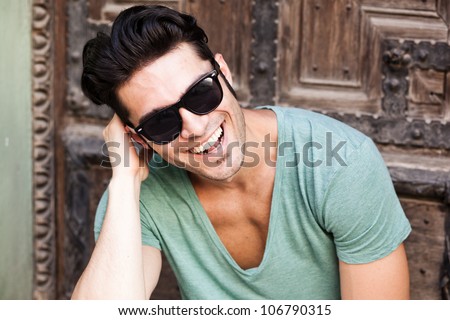 close-up of attractive man smiling wearing sunglasses