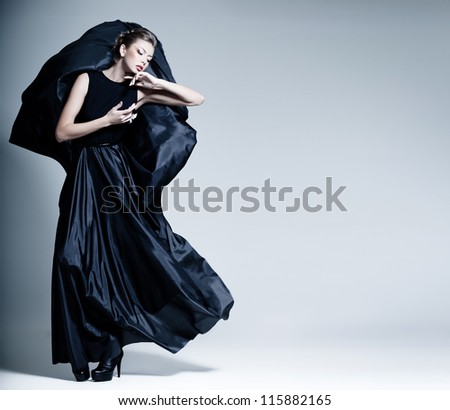 beautiful woman model dressed in an elegant dress in a fashion pose
