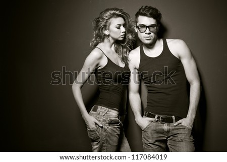 Sexy man and woman doing a fashion photo shoot in a professional studio
