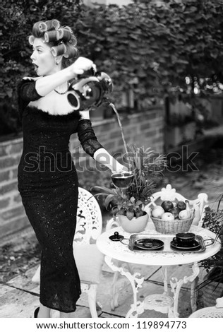 sexy woman pouring tea funny concept - fashion shoot (intentional soft focus and vintage look)