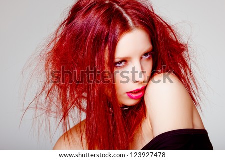 portrait of sexy red haired woman, wild hair style - beauty shoot in the studio