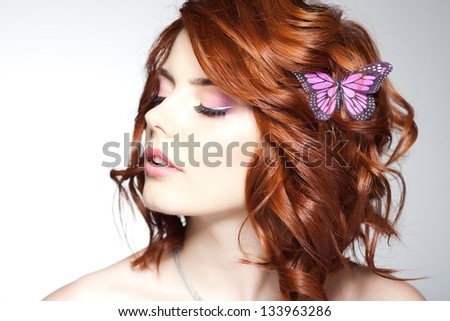 pretty woman with a butterfly in her hair - beauty shot