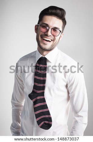 sexy man dressed elegant with s sock tie laughing- funny concept