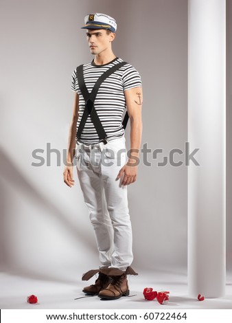 very attractive young man model dressed like a sailor - full body studio shoot
