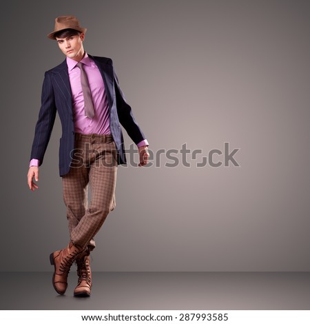 Handsome young male model posing in the studio, clean composition - copy space