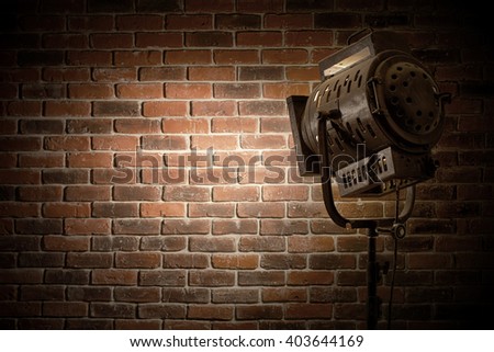vintage theater / movie spot light focused on a brick wall background