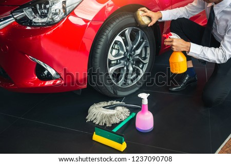 Man asian inspection and cleaning Equipment car wash With red car For cleaning to quality to customer on car showroom of service transport automobile transportation automotive image.
