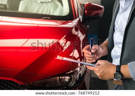 man writing on notepad or book, paper with car on wood background. Using wallpaper or background for note, transport, business, copy space image.