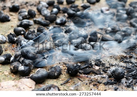 thai tradition cashew nut burned from stove charcoal with hot smoke on ground