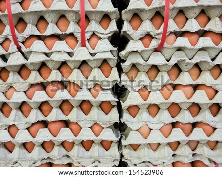 Stacked of eggs for wholesale at the supermarket, ready to shipping