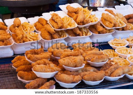 Fresh fried chicken and French fries on food shop