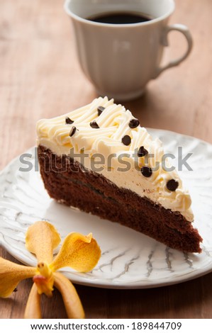 Slice piece of vanilla cake topping with white chocolate chips for coffee or tea break