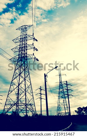 Energy Distribution Network - Electricity Pylons against Orange and Yellow Sunset