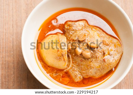 Close up Muslim style chicken and potato curry or chicken mussaman curry - deep focus image with path