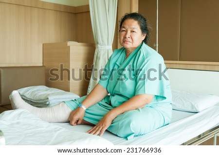 senior woman with broken leg in hospital