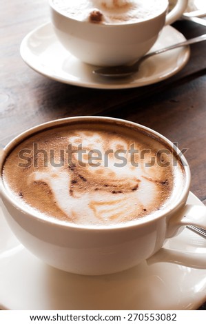 Latte\' Art Coffee,Cup of latte coffee on wooden background
