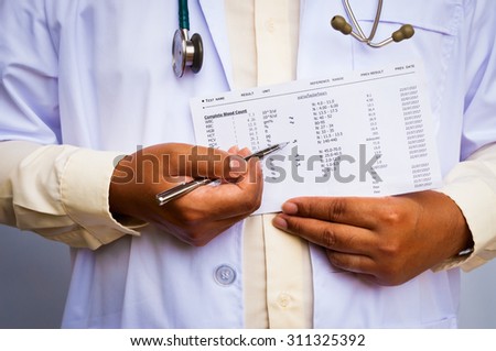doctor with a stethoscope showing abnormal lab result