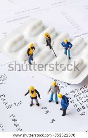 miniature people on the drugs or pils with medical check up lab result, medical concept